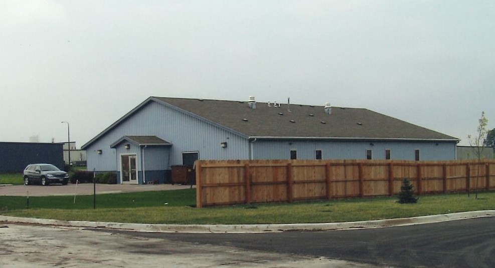 Blue shelter building surrounded by a fence