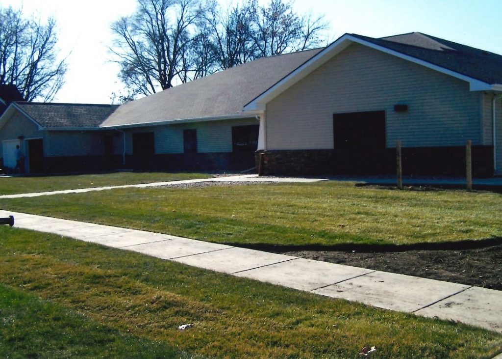 Exterior of 1950's style brick home with large entrance.