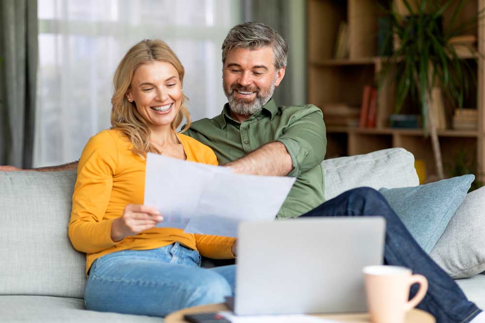 Couple sitting together and reading a document