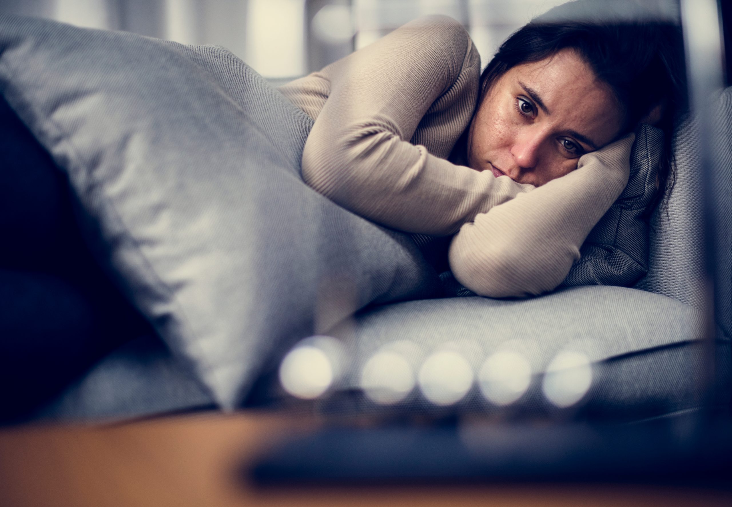 Depressed,Woman,Lying,On,The,Bed