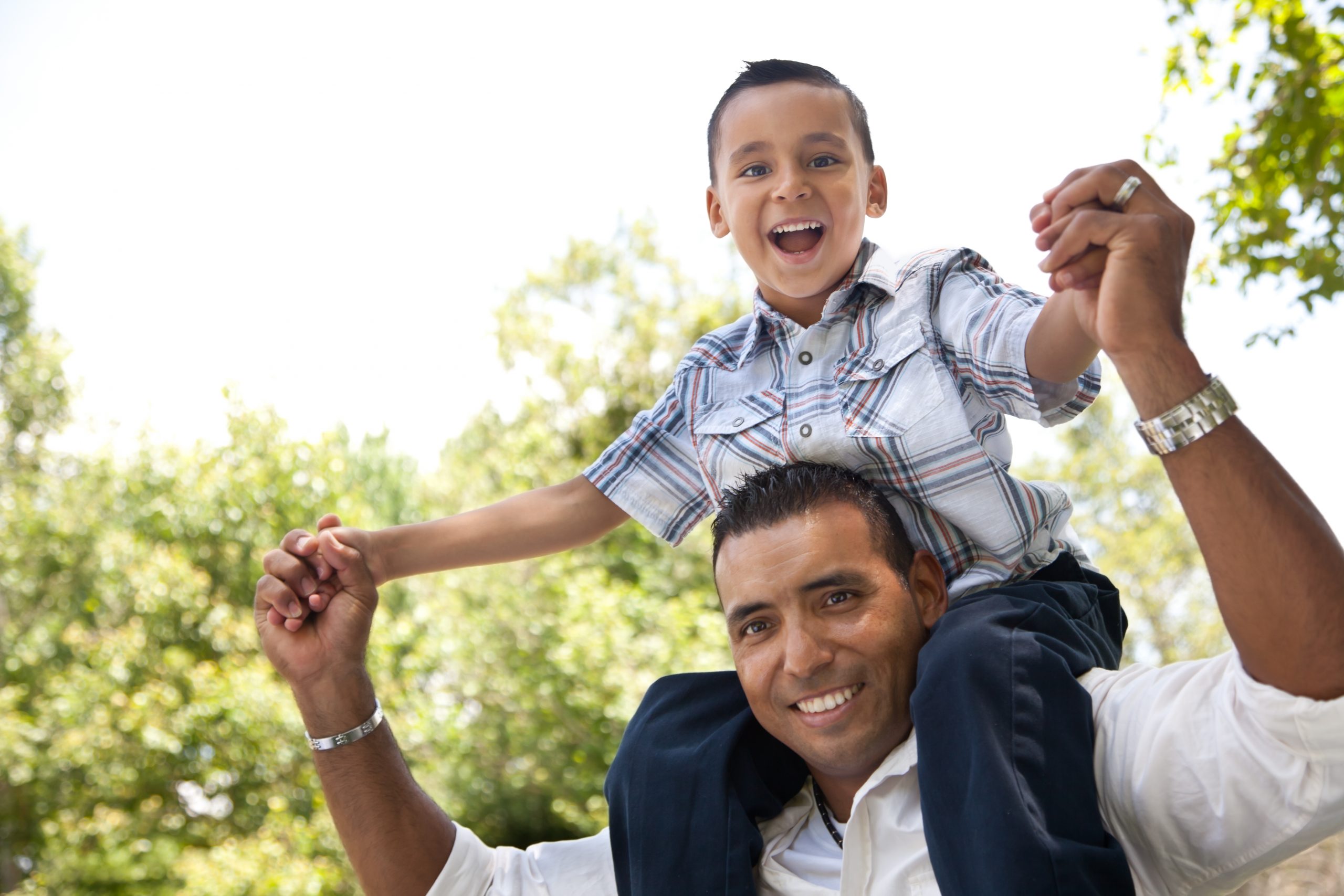 Hispanic,Father,And,Son,Having,Fun,Together,In,The,Park. 