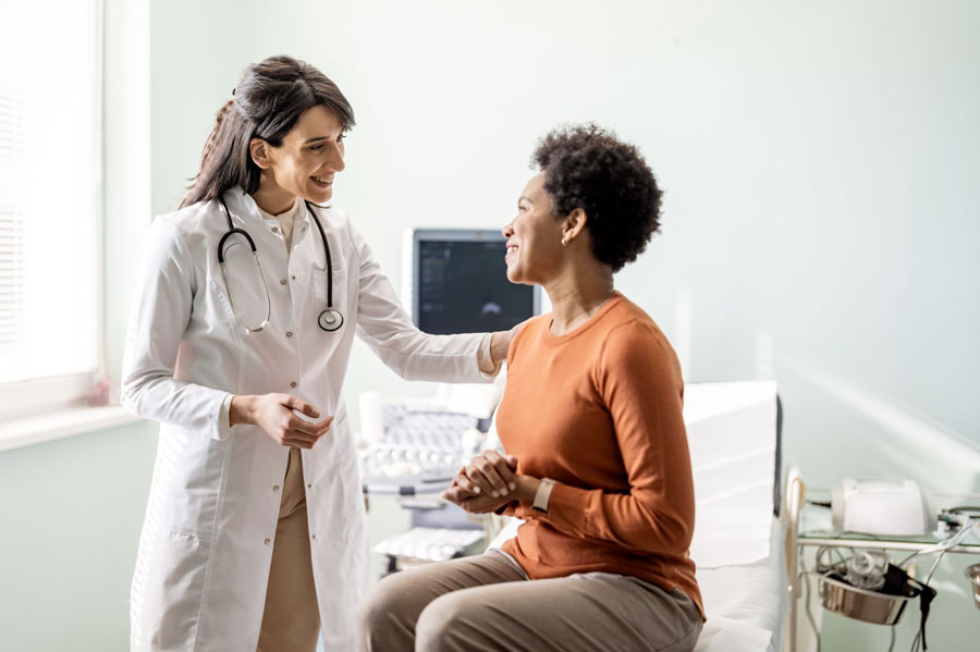 Female medical practitioner reassuring a patient