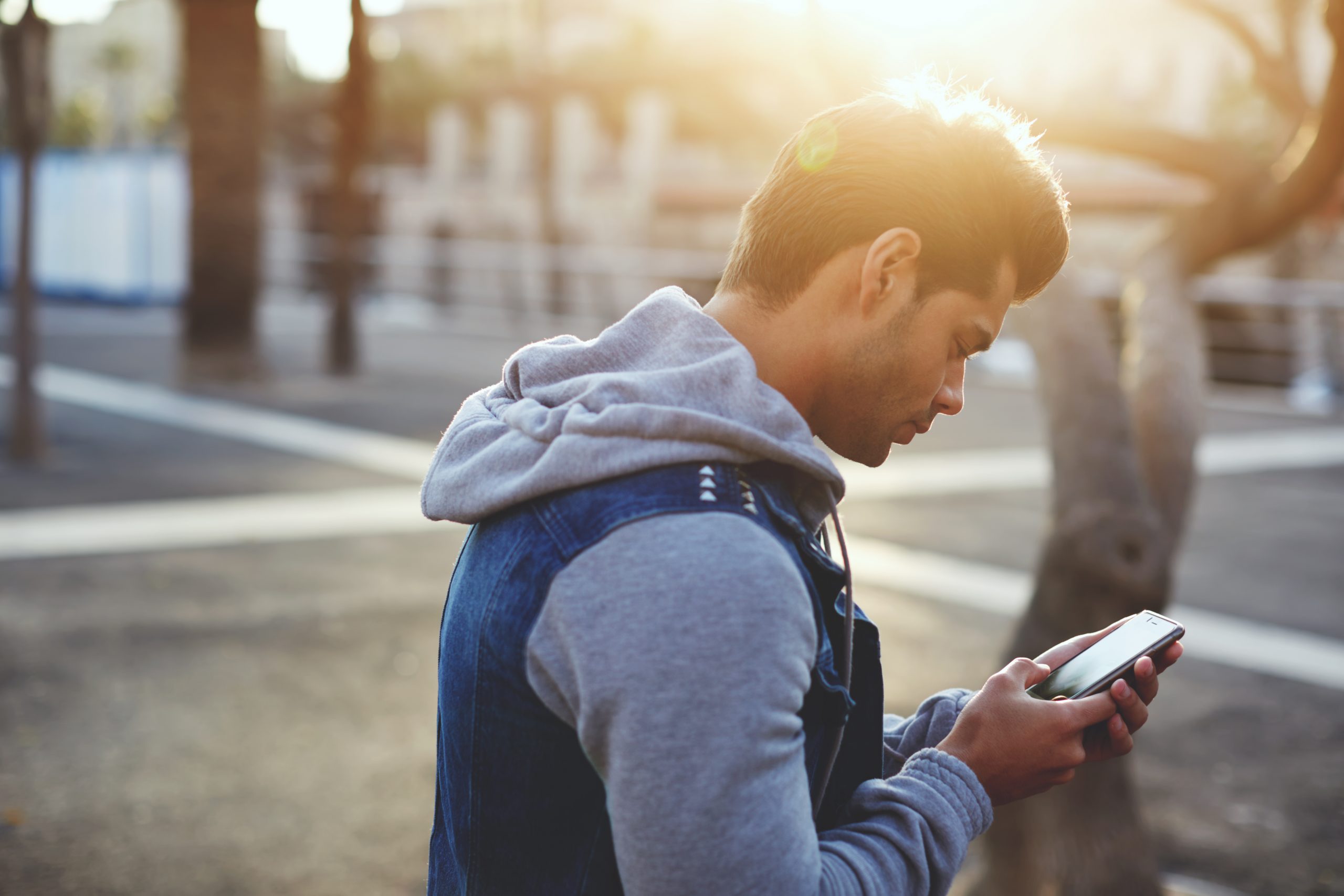 Portrait,Of,Handsome,Young,Man,Sending,A,Text,Message,While